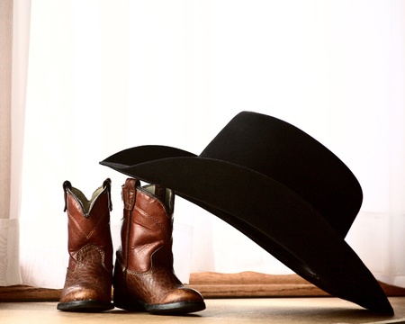 Cowboy hat leaning on bootsの写真素材
