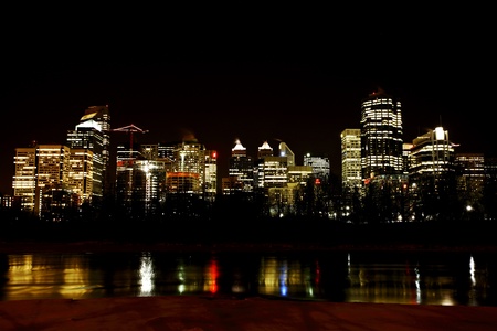 lit buildings reflected off waterの写真素材