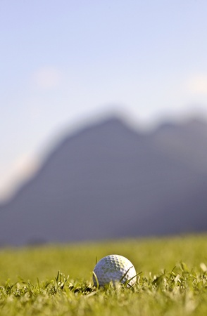 Golf ball with blurred mountains in backgroundの写真素材