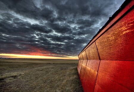 Sunset Saskatchewan Canada red sky farm granary barnの写真素材