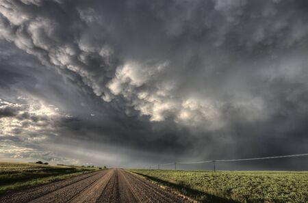 Storm Clouds Saskatchewan billowing clouds and gravel roadの写真素材