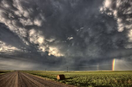 Storm Clouds Saskatchewan billowing clouds and gravel roadの写真素材