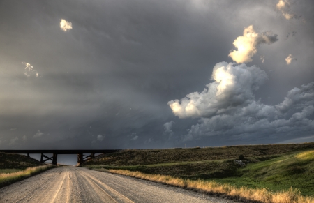 Storm Clouds Saskatchewan billowing clouds and gravel roadの写真素材