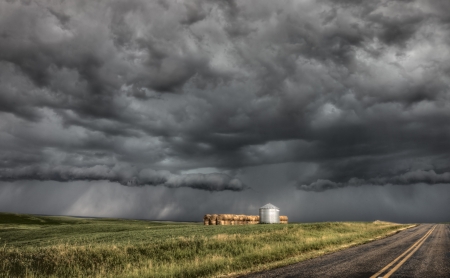 Storm Clouds Saskatchewan billowing clouds and paved roadの写真素材