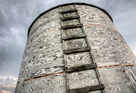 Storm Clouds Saskatchewan old wooden granary with ladderの写真素材
