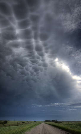 Storm Clouds Saskatchewan billowing clouds and gravel roadの写真素材