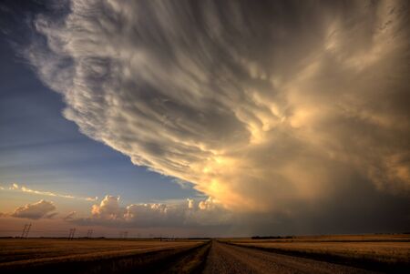 Storm Clouds Saskatchewan billowing clouds and gravel roadの写真素材
