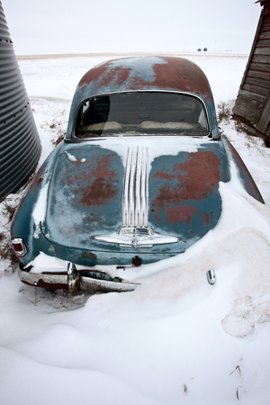 Antique abandoned car  in winter canadaの写真素材