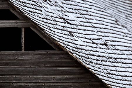 Roof on wooden barn in winter shinglesの写真素材