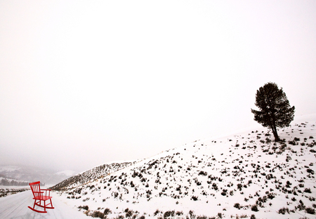 Lamar Valley Winter Yellowstone red chair on roadの写真素材