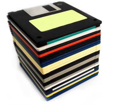 close up of stack of floppy discs on white background