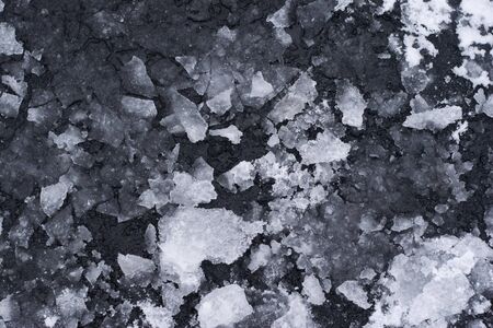 Broken Ice melting on Asphalt