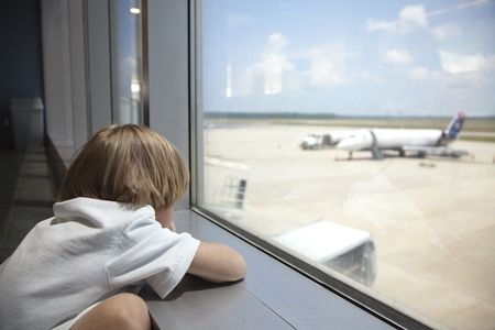 Young Boy waiting for an airplane.の写真素材