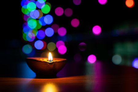Earth diya lightened during diwali festival infront of home in the evening. Colorful bokeh light background. Used selective focus and with copy space.の写真素材