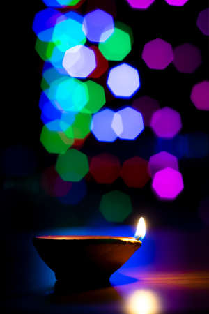 Diya lightened during diwali festival of Hindu religion in India. Colorful bokeh light background. Used selective focus.の写真素材