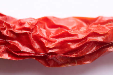Close up of red chilli pepper with texture on it and white background. Used selective focus.