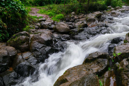 Rain water flowing at the base of waterfall during monsoon season.の写真素材