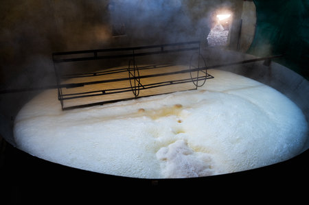 Sugarcane Jaggery in making by boiling sugarcane juice to make concentration, frothing at upper...