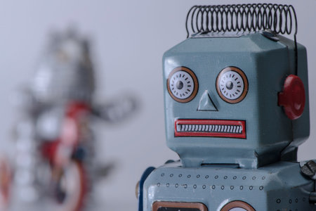 vintage tiny toy robots on white background selective focusの写真素材