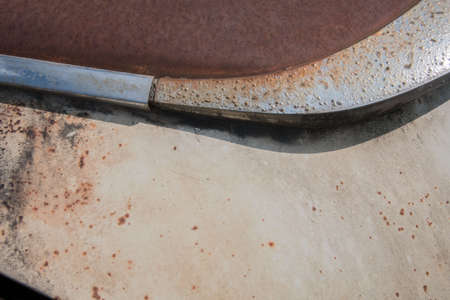 Partial view of the front of an old rusty carの写真素材