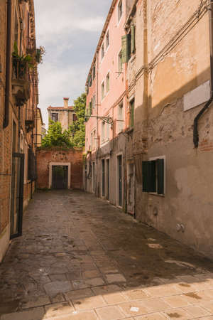 narrow alley in the world famous lagoon city veniceの写真素材