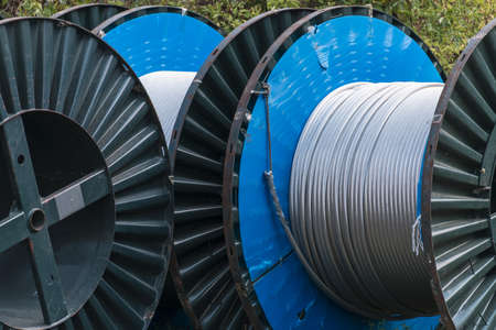 large rolls of coiled silver metal power cablesの写真素材