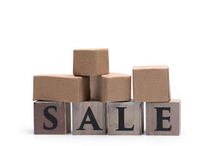 Packages on wooden cubes representing the word Sale isolated on a white background