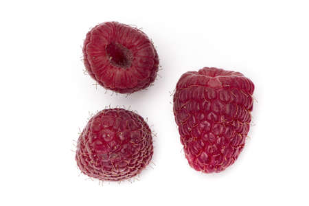 Close up of three ripe red raspberries seen from different sides isolated on white background