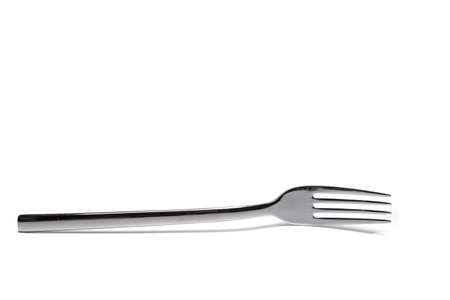 Close up of metal dinner fork isolated on white backgroundの写真素材