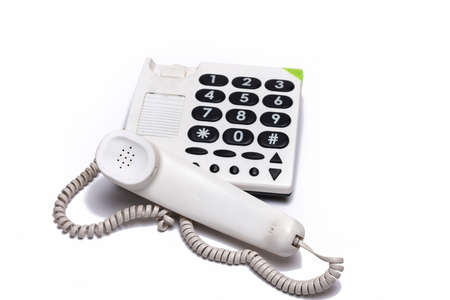 Close up of white landline phone with large buttons isolated on white background