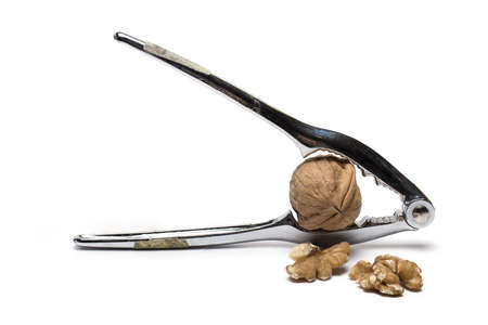 Close up of metal pliers to open nuts with walnut nutcracker isolated on white background