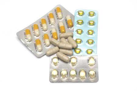 Close up of different blister with different tablets and medicine and several tablets in between on...