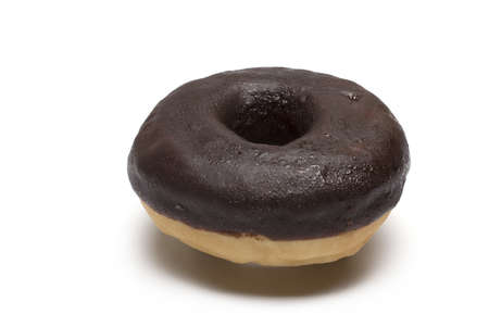 Close up of chocolate covered donut on white backgroundの写真素材