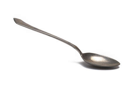 Close up of old retro vintage silver dessert tea spoon on white backgroundの写真素材