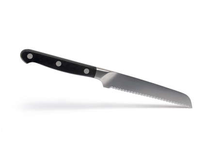 Close up of high quality small bread knife with black handle and serrated blade against white...