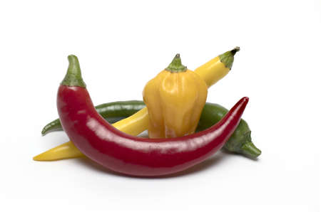 Close up of several different colored chili peppers with different shapes as spice and ingredient...