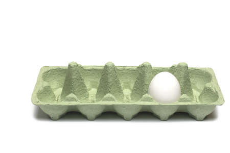 Close up of an open green cardboard egg carton box with single white egg inside on white background