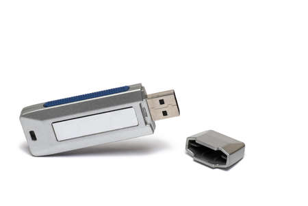 Close up of opened silver USB flash drive stick data storage device with lid next to it on white...