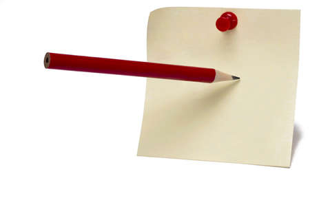 Close up of yellow postit note sheet with red pin and pointed pencil which points to write on the sheet against white background concept for notesの写真素材