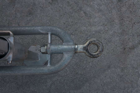partial close up of massive heavy gray metal steel trailer drawbar hitch seen from aboveの写真素材