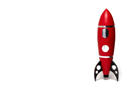Close up of red toy baby kids rocket with black supports and silver door and window on white backgroundの写真素材