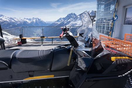 Close-up of a snowmobile of the piste rescue service parked in front of a lift station in Saint Anton at the Arlberg in Austria.の写真素材