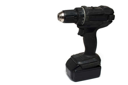 Close up of professional black cordless screwdriver with plugged battery pack on white backgroundの写真素材