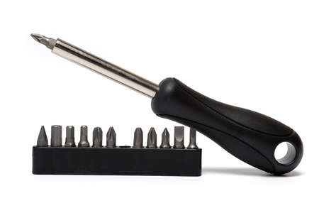 Close-up of a flexible screwdriver with various bits with black rubberized handle on white...