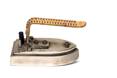 Close up of small very old retro vintage heating iron to take with you when traveling on white background