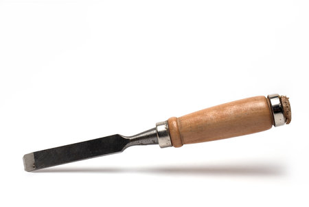 Close up of sharp chisel from carpenter workshop with wooden handle on white backgroundの写真素材