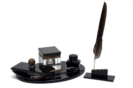 Close up of elegant black old retro vintage bakelite office tools fountain pen with nib desk set inkwell and rocker to dry ink on white backgroundの写真素材