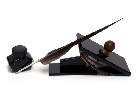 Close up of elegant desk set with several bakelite office items like tray inkwell ink pen pen holder and rocker for ink drying on white backgroundの写真素材