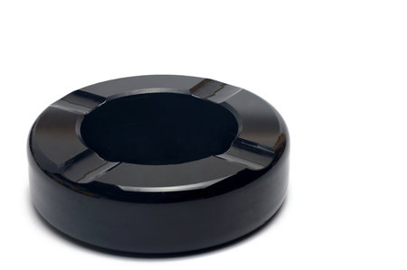 Close up of black old retro vintage elegant round bakelite asian with four cigarette rests on backgroundの写真素材