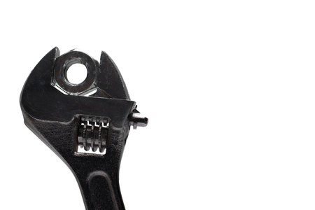 Close up of adjustable solid open end wrench adapted to inserted nut for fastening different size...